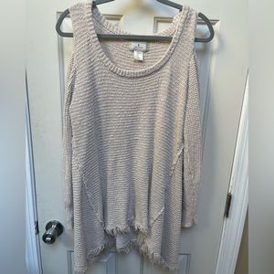 Free people shoulder cut out cream sweater. Has intentional “worn” look